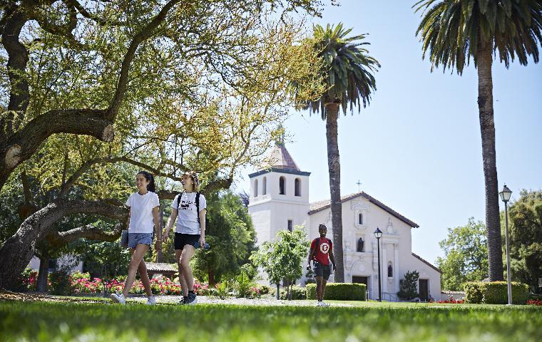 Photo of students walking with Mission in backgroun
