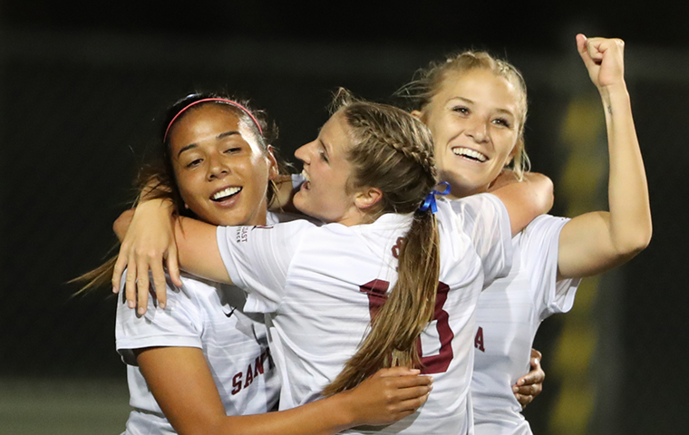 Soccer players celebrate goal