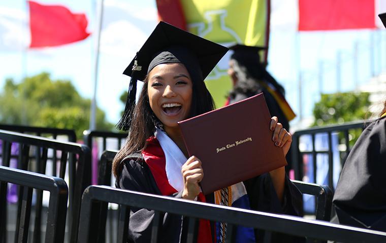 Graduate holding diploma