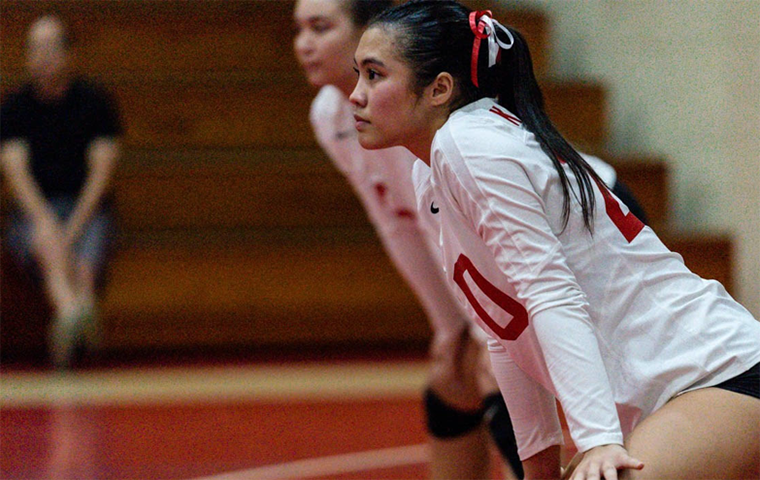 Hallie Wigsten stands in the ready position in a volleyball match