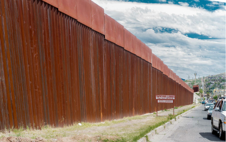 A terra cotta colored wall along the Kino Border Project image link to story