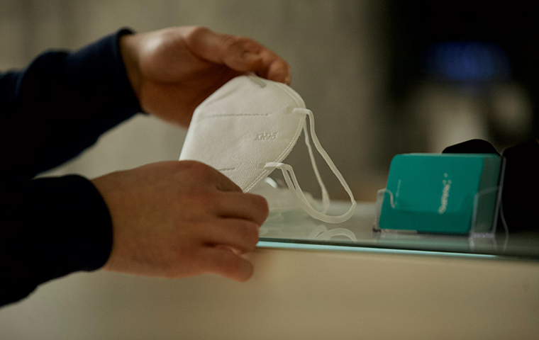 Hands holding mask on counter
