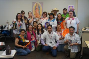 A group photo of people at an educational event indoors.