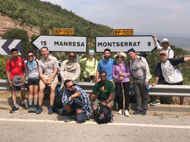 A group of people posing near road signs at 