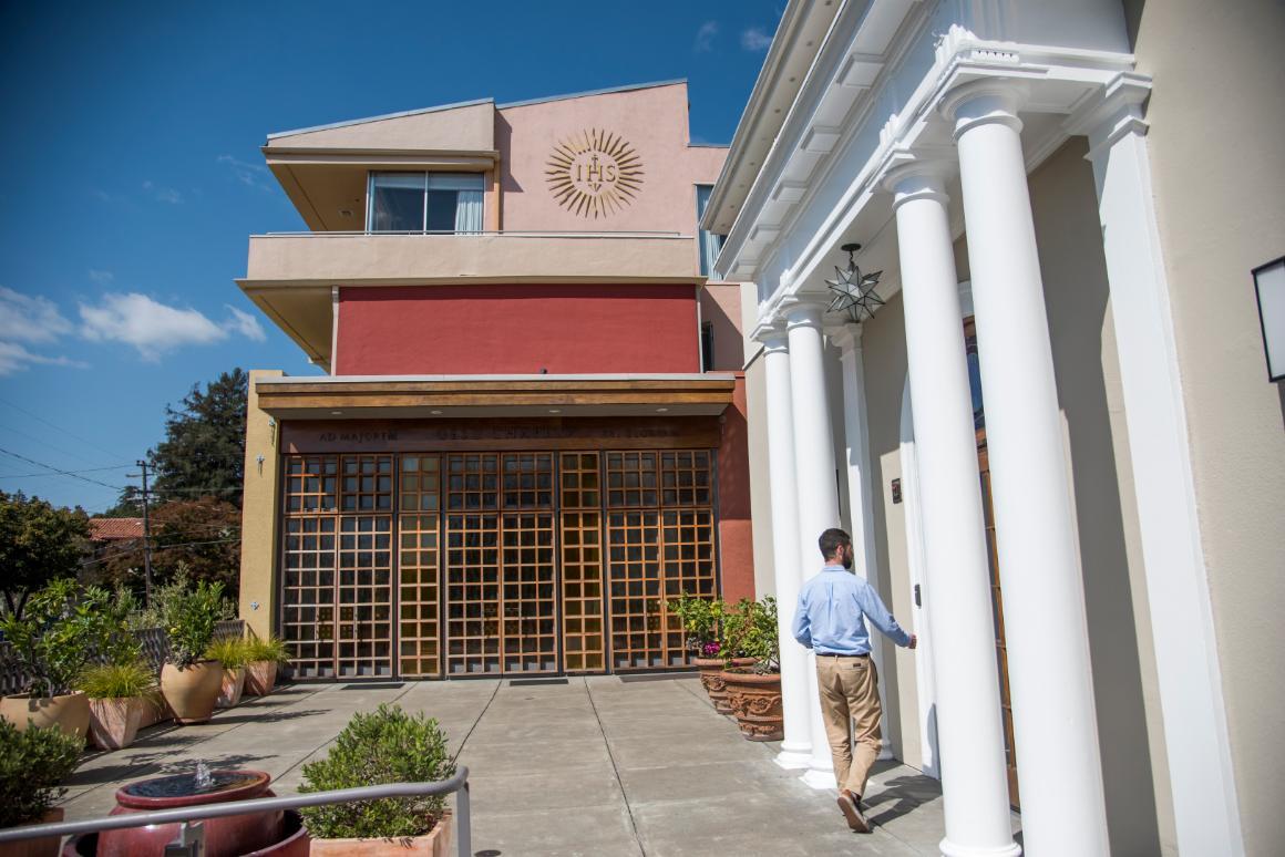 A person enters a building labeled 