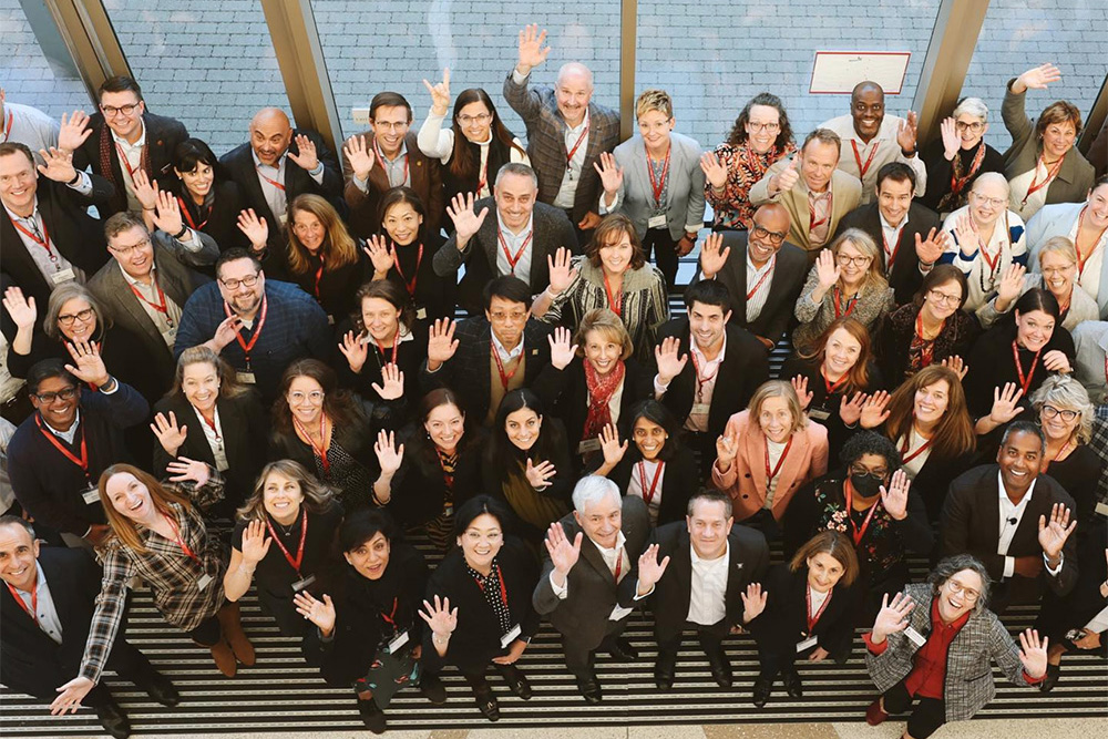 Group of workers waving up at camera
