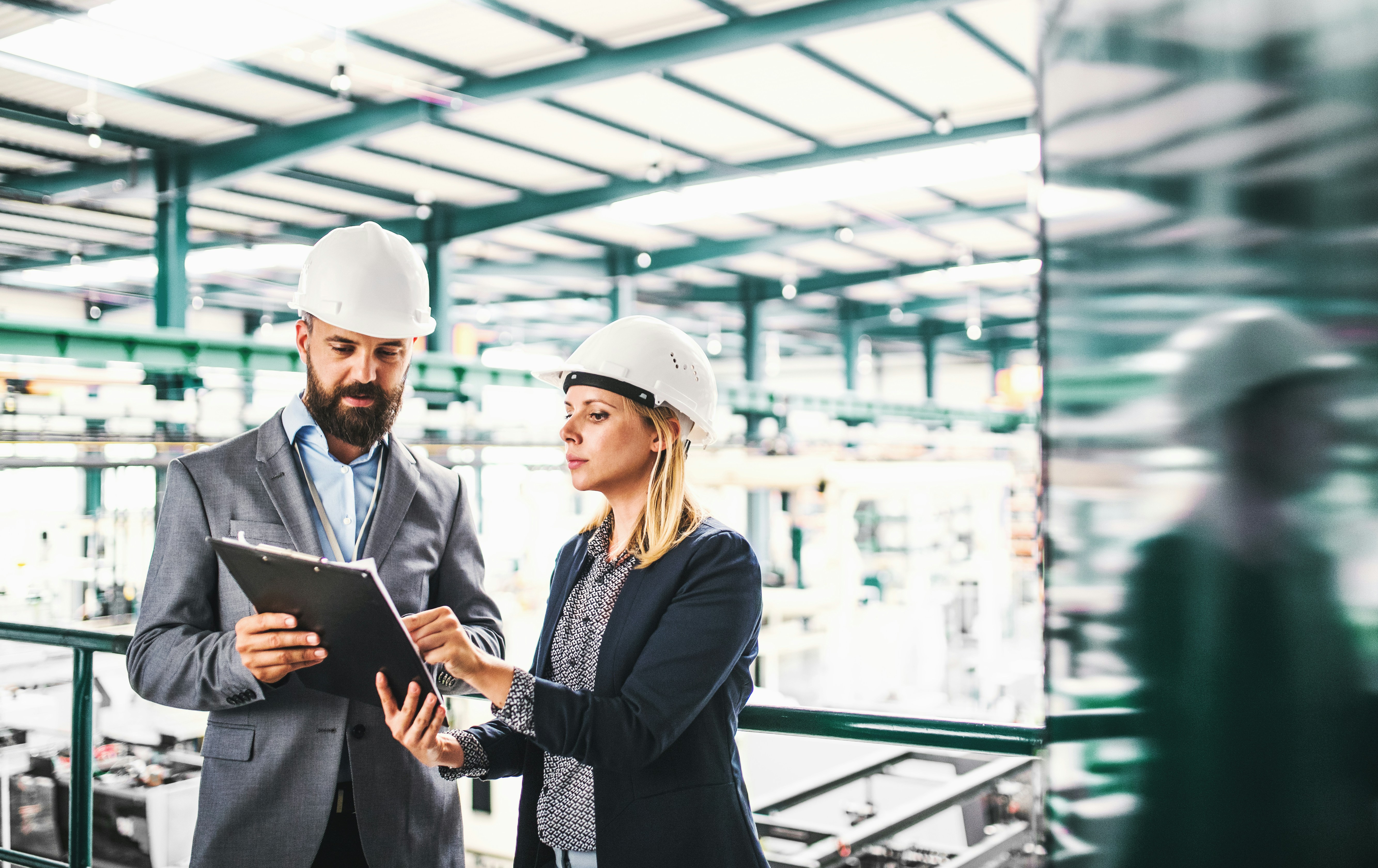 Man and woman discussing sustainability over a clipboard