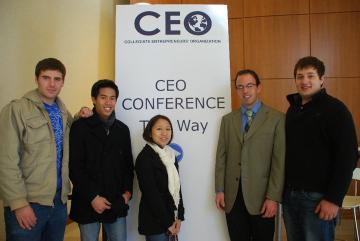 Five people standing in front of a 