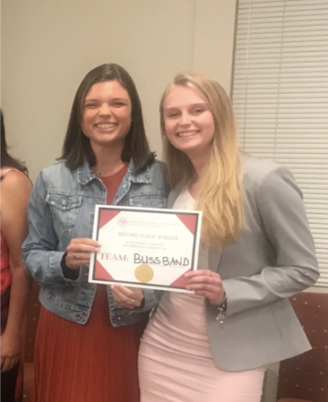 Two women smiling and holding a '2nd Place Winner' certificate.