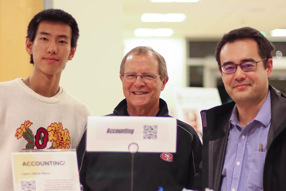 Three people holding a Ciocca Center certificate and smiling.