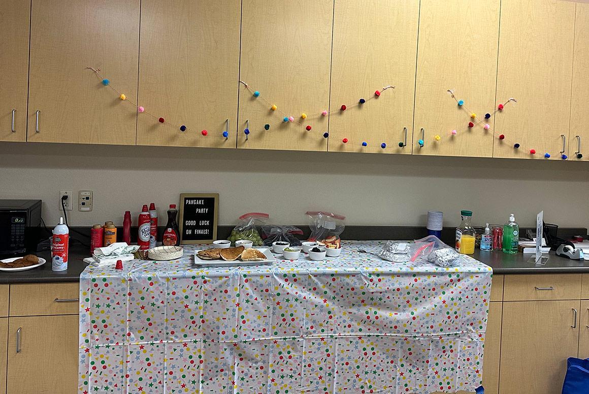 A decorated table with dishes, water bottles, and food items.