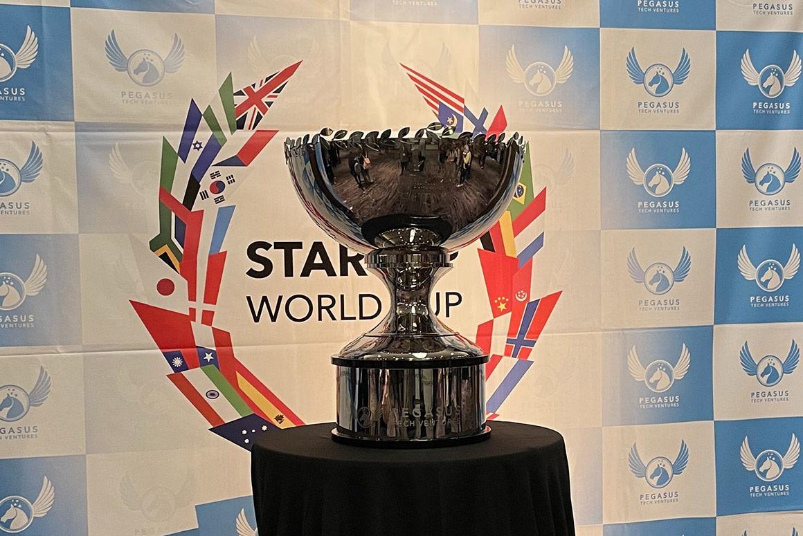 Trophy with Startup World Cup text in front of a Ciocca Center backdrop.