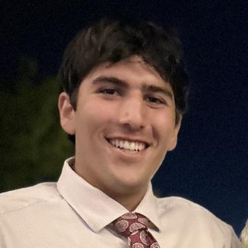 Man in shirt and tie smiling