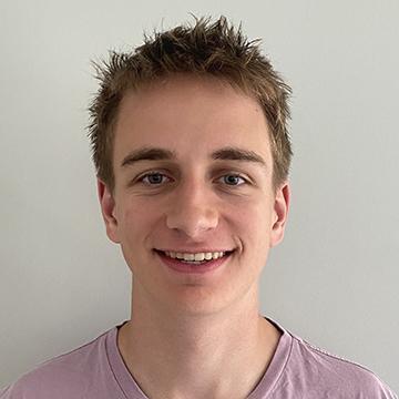 Man smiling in brown tshirt