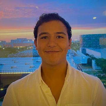 man in button down shirt smiling outdoors