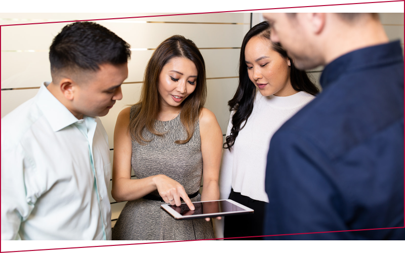 person in black suit jacket holding white tablet computer
