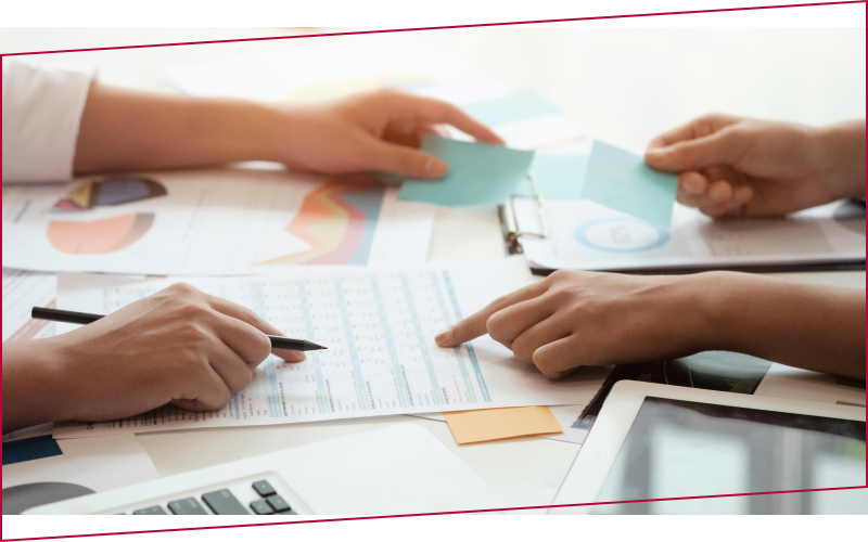 person writing on white paper, scrabble tiles and smartphone