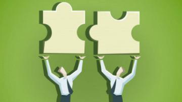 Two identical figures holding up large puzzle pieces.