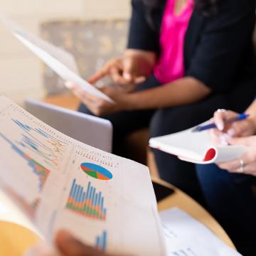 Leavey School of Business students analyzing charts