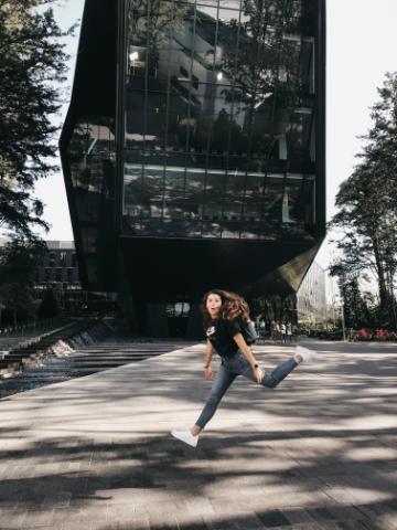 Retail Management Institute Student jumping in mid air