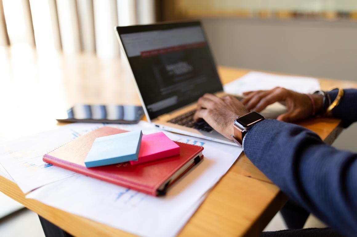 Student researching the Leavey School of Business on their laptop