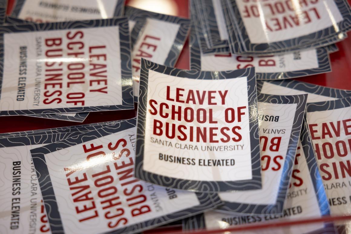 A tray full of Leavey School of Business stickers