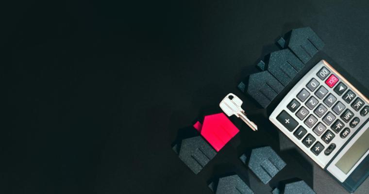 House-shaped models, a house key, and calculator