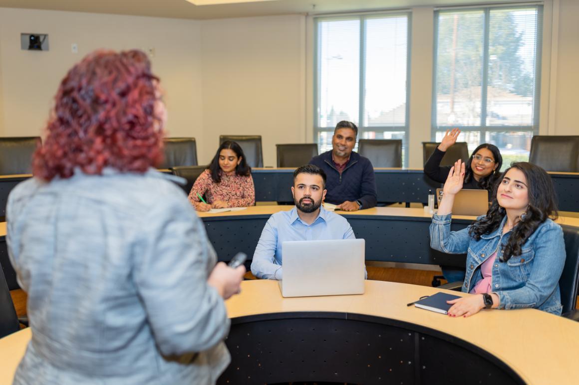 MBA candidates raising their hand in Jo-Ellen Pozner class
