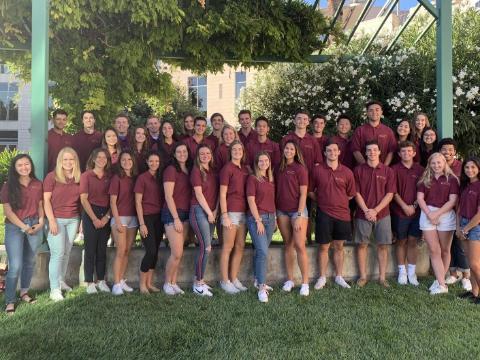 Group of peer advisors in matching shirts posing outdoors, 2019-2020.