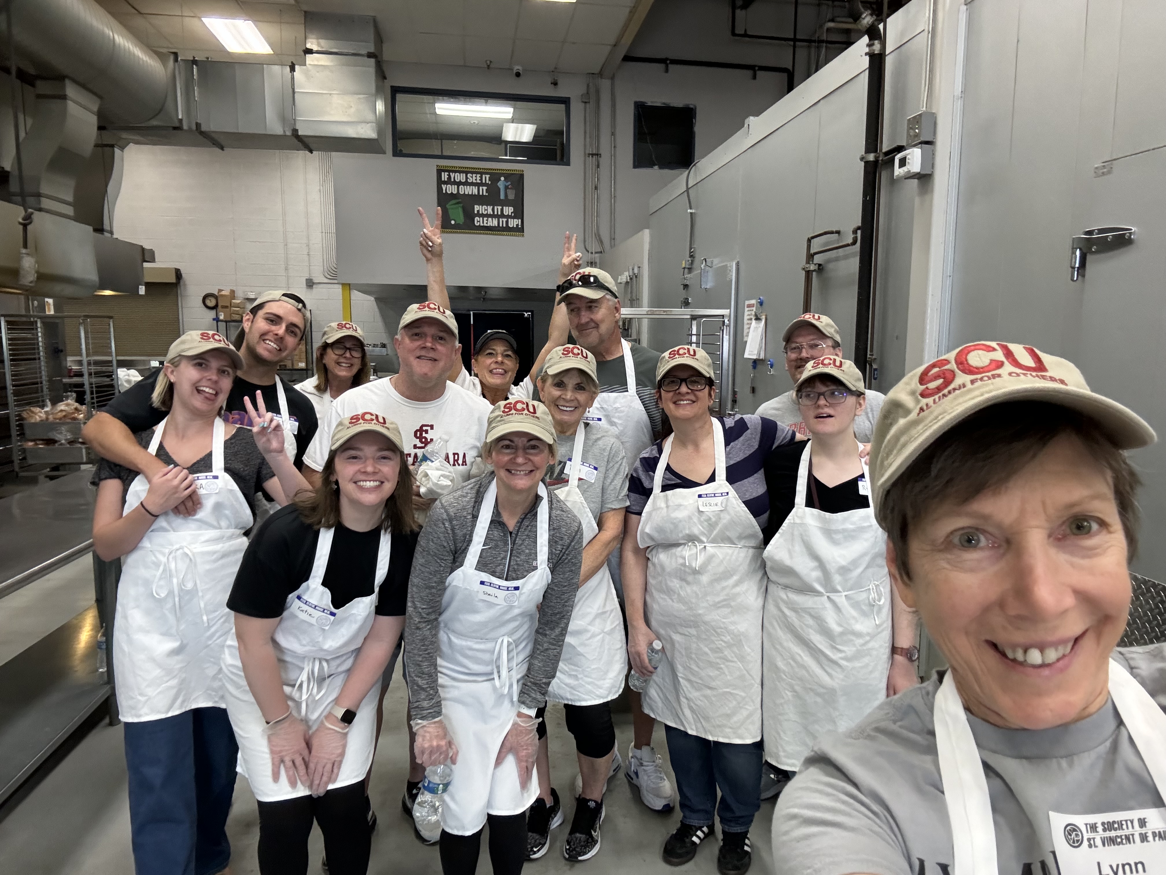 alumni selfie wearing aprons