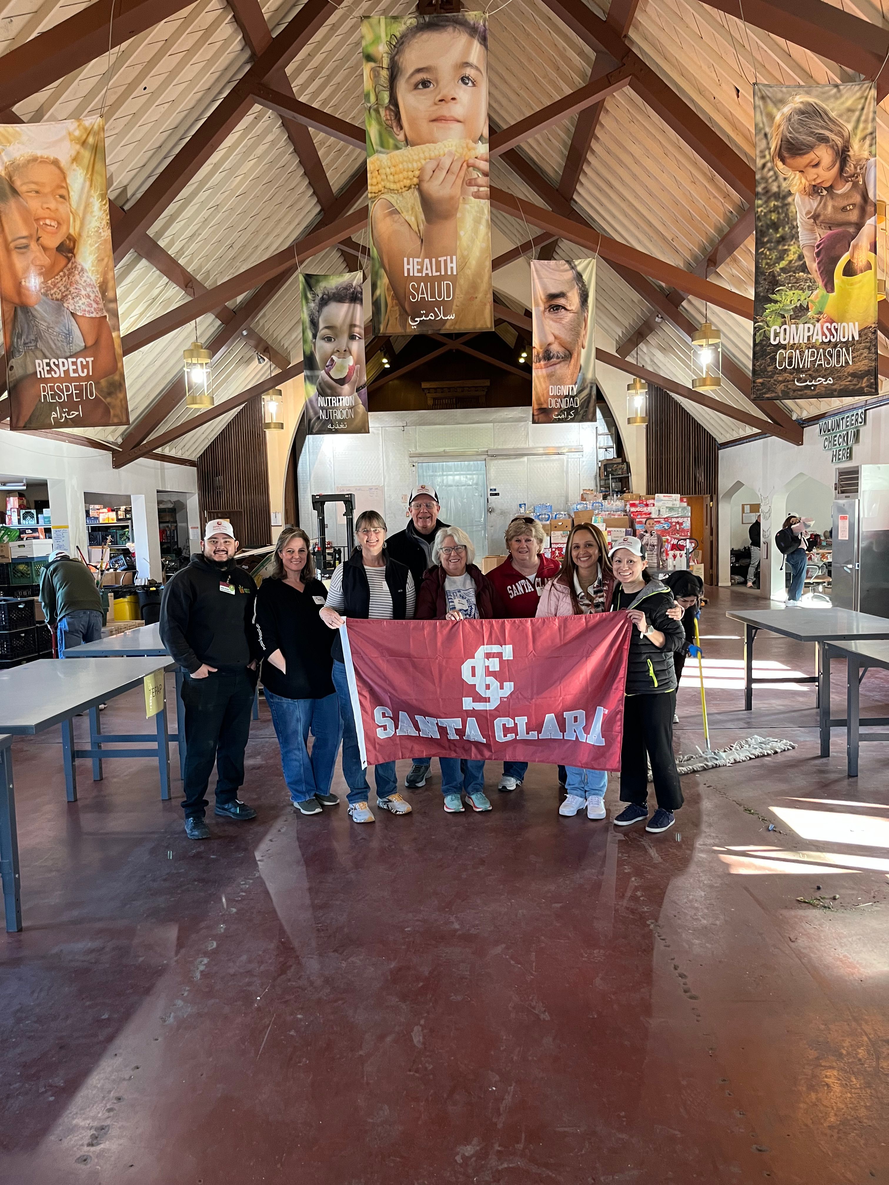 Alumni holding up SCU flag