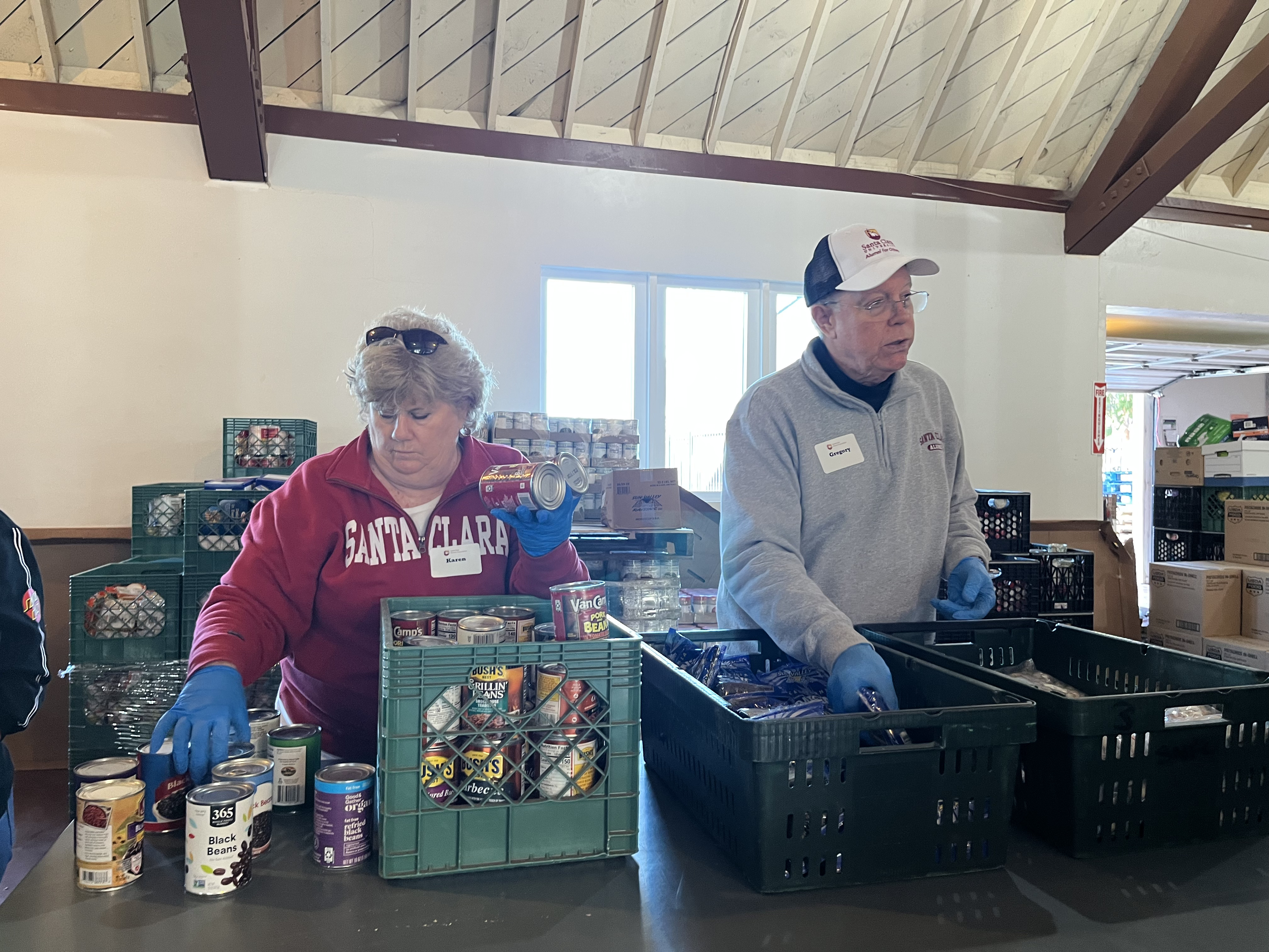 Two volunteers distributing food