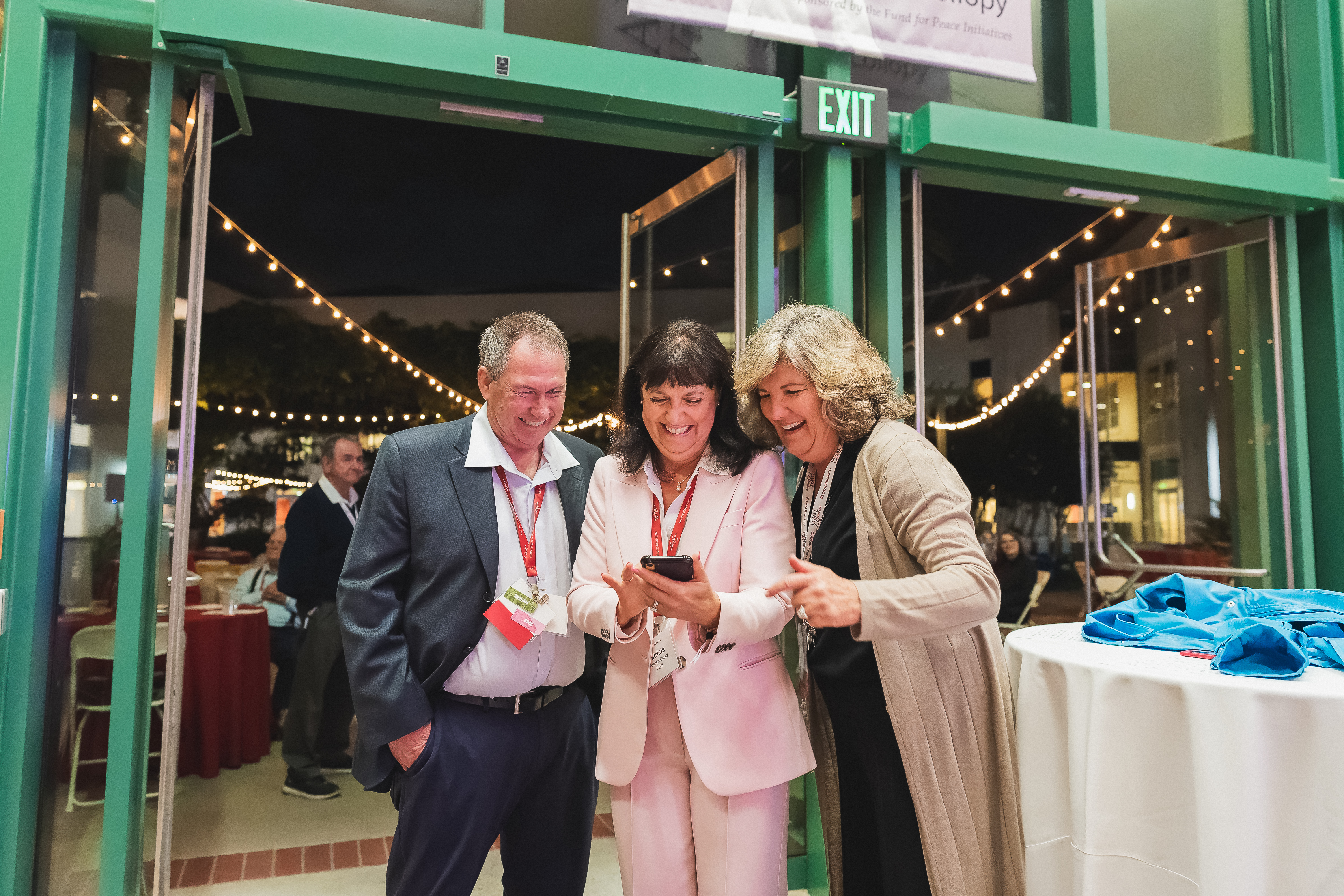 Alumni Happily on their phone 