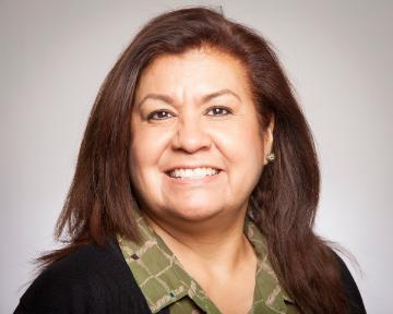 A woman smiling in a headshot photo.