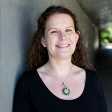 A smiling woman with a green pendant, titled 'Olga Rocklin Psychotherapy'.