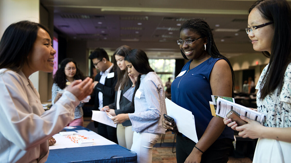 Women talking at a career fair.