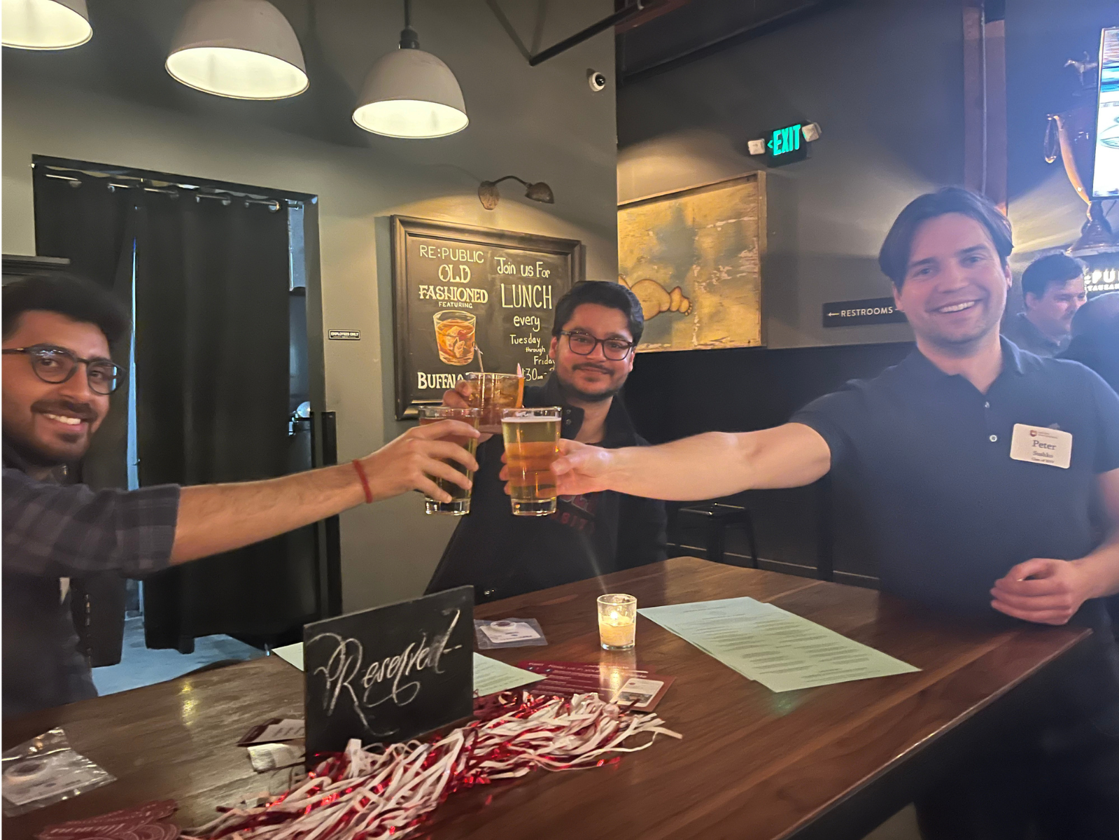 3 men cheering their beers