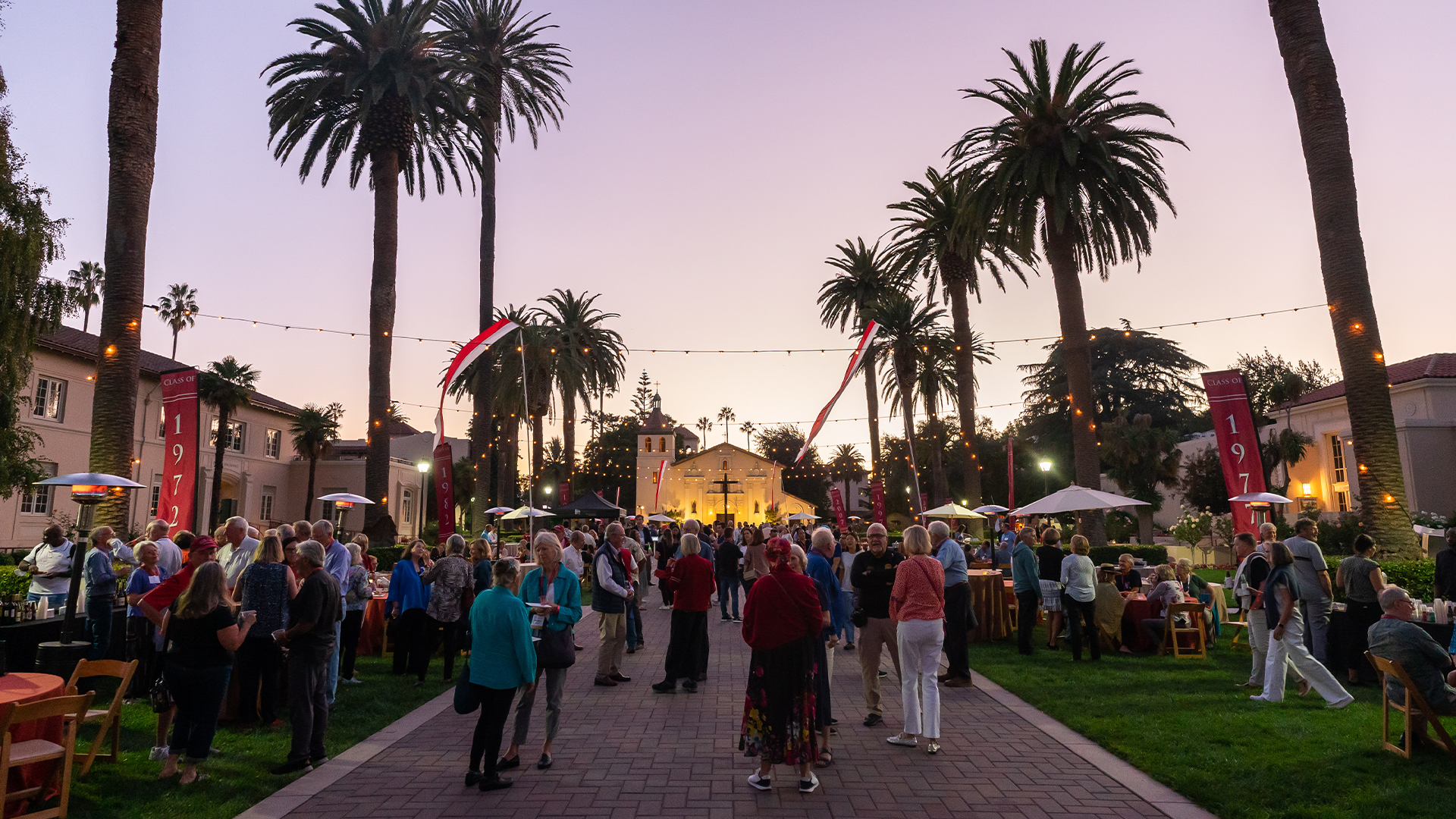 A large crowd of alumni mingling on Abby Sobrato Mall