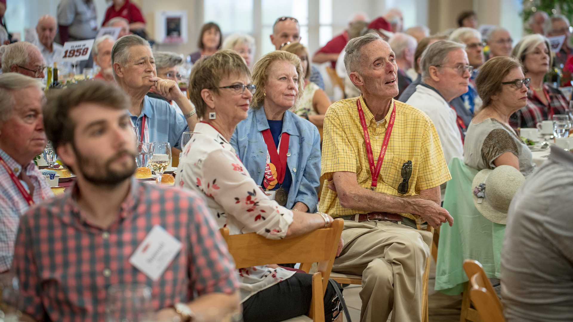 A group of people looking paying rapt attention to a speaker