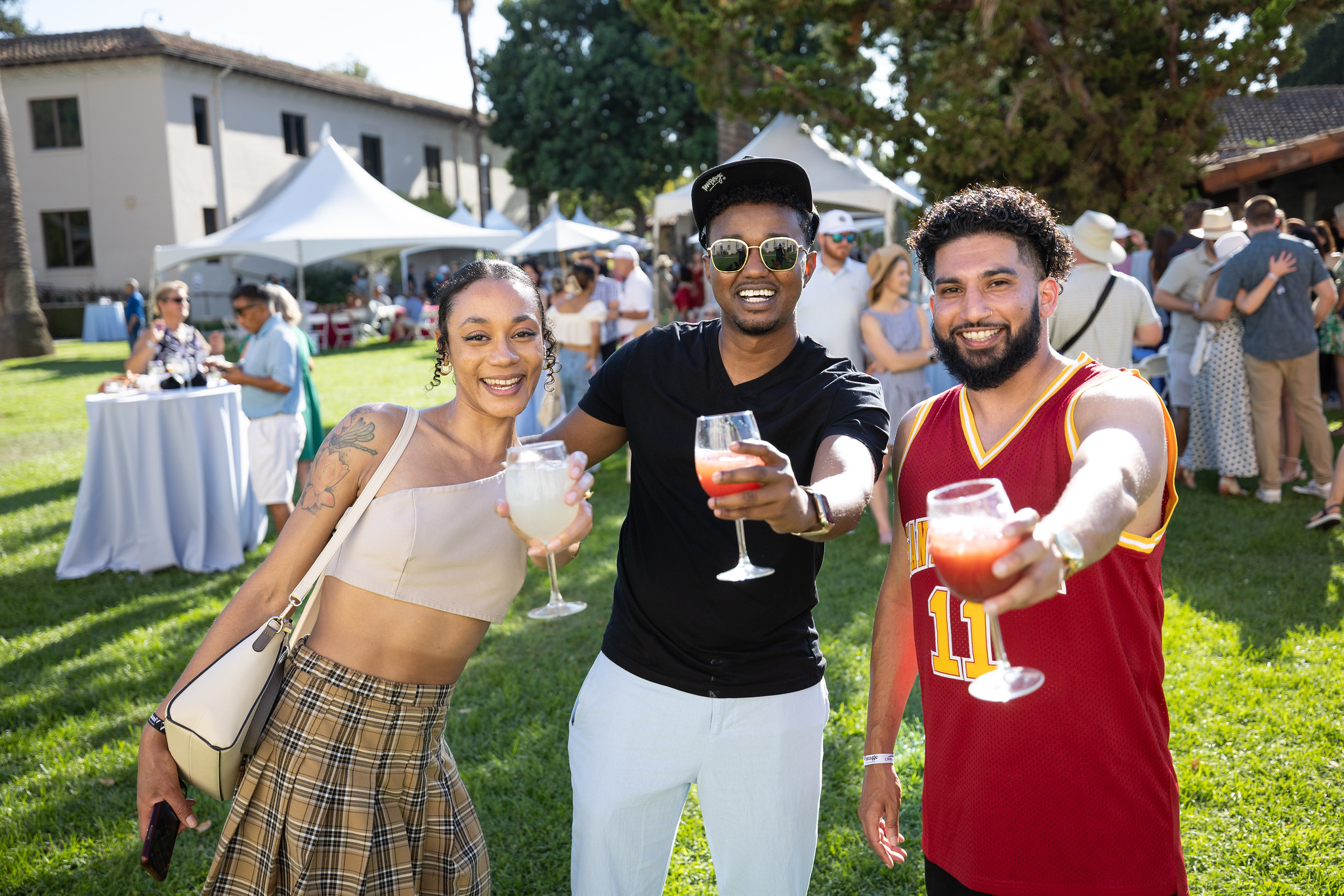 Three alumni cheers the camera in the Mission Gardens at Vintage Santa Clara 