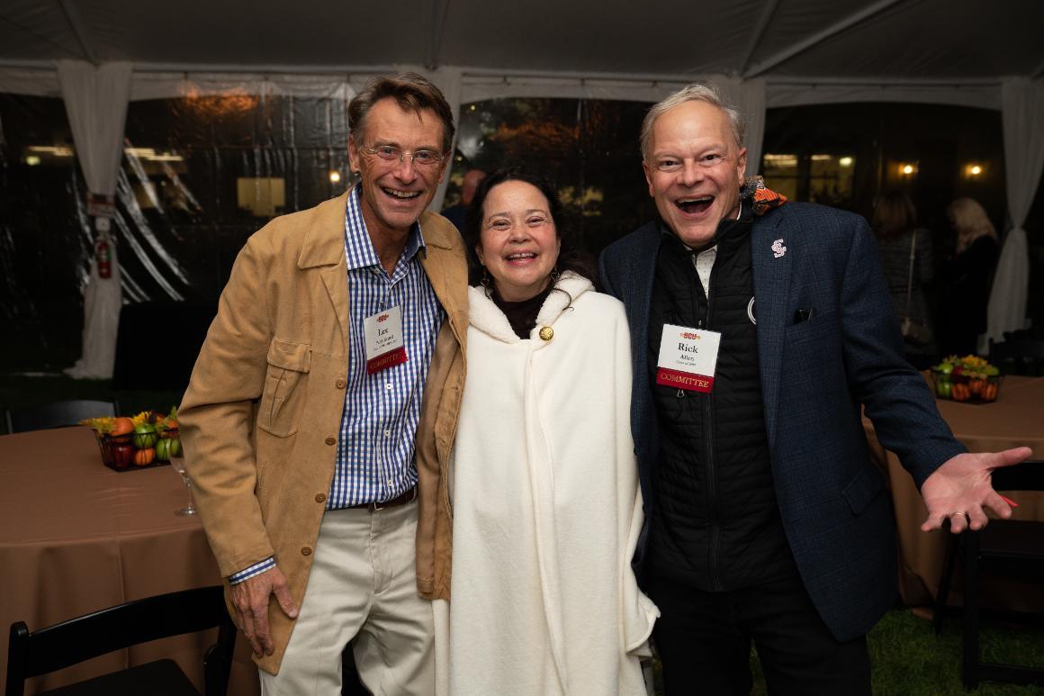 Two men and a woman laughing at the camera at Santa Clara University's Grand Reunion.