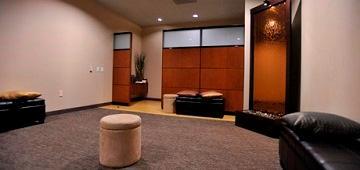 A spacious meditation room with cushions and a serene ambiance.