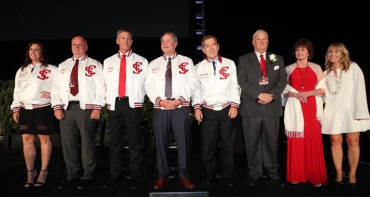 A group of people standing together on a stage at 