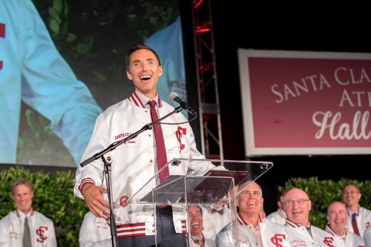 A person speaking at a podium at Nash HOF induction.