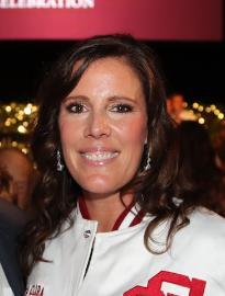 A woman smiling at an event.