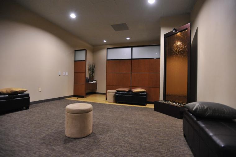 A serene meditation room with minimalistic seating and a single table.