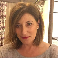 A person smiling indoors.