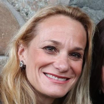 A person with a background of stone bricks.