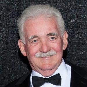 A person in a black tuxedo with a bow tie.