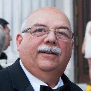 A man in a tuxedo at an event.